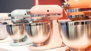 KitchenAid stand mixers lined up on a display, each in a different color