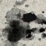 Oil and grease splattered on a concrete drive