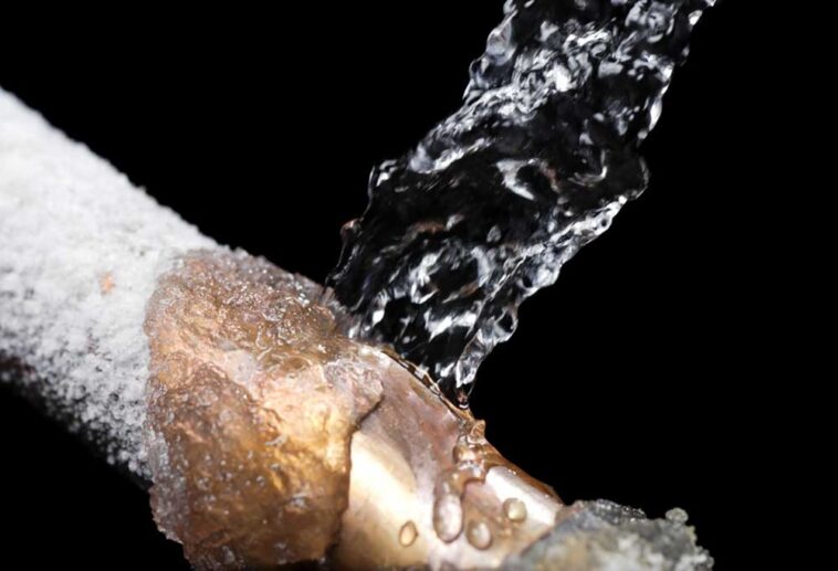 Burst frozen pipe on a black background