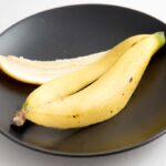 Banana peel on a black dinner plate