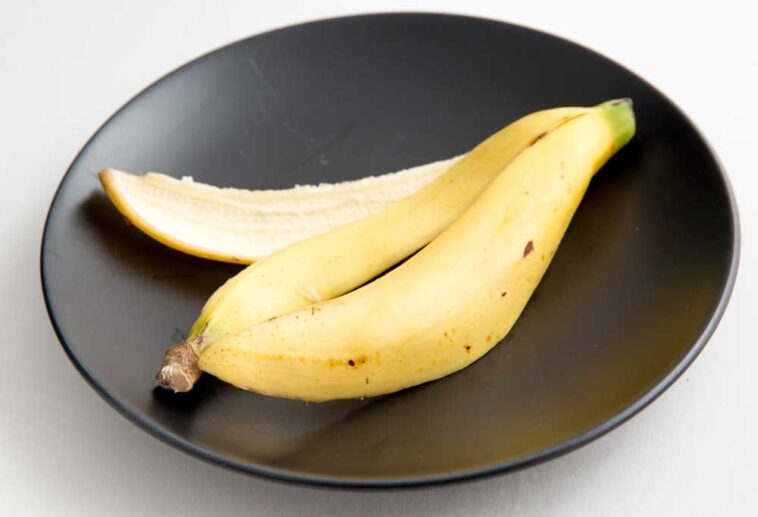 Banana peel on a black dinner plate