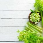 vairety of cuts of celery on a slatted wooden surface