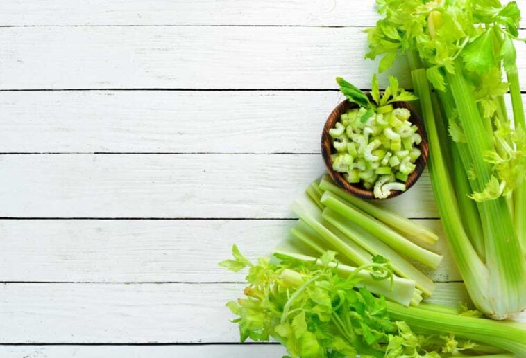 vairety of cuts of celery on a slatted wooden surface