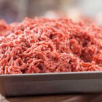 Ground beef in a tray on a wooden table