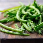 Fresh greenbeans on a wooden cutting board
