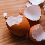 Brown eggshells on a wooden board