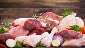 Variety of raw meat on a wooden table