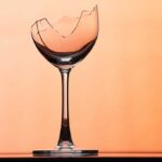 Broken wine glass on a orange background