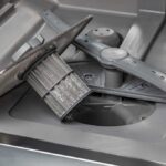 The bottom of the inside of a dishwasher, taken apart