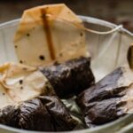 Used tea bags in a strainer