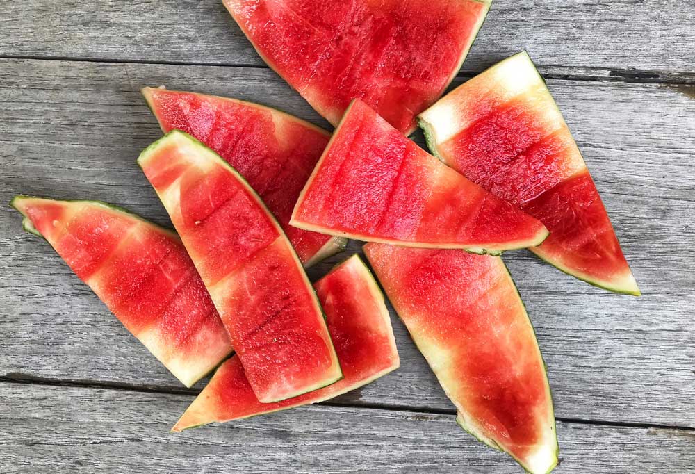 Watermelon rinds on a wooden surface