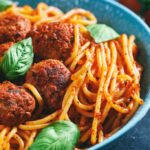 Close up of spaghetti and meatballs in a blue bowl