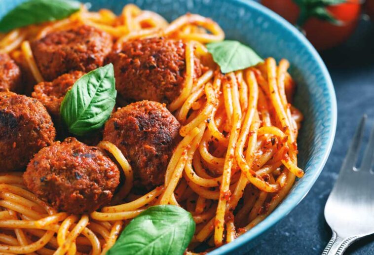 Close up of spaghetti and meatballs in a blue bowl