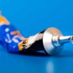 Tube of super glue on a bright blue surface
