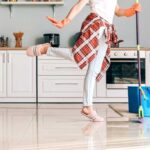 Woman in pink slippers mopping the kitchen floor