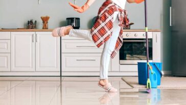 Woman in pink slippers mopping the kitchen floor