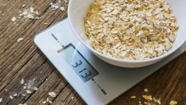 Digital kitchen scale with a bowl of oats in it being weighed